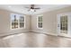 Bright living room with wood-look flooring and multiple windows at 3329 Hughes Gasque Rd., Aynor, SC 29511