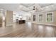 Open living room with tray ceiling, hardwood floors, and access to the kitchen at 3329 Hughes Gasque Rd., Aynor, SC 29511