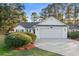 White house with gray roof, two-car garage, and manicured landscaping at 3604 Farmington Pl., Myrtle Beach, SC 29579