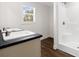 Double vanity bathroom with dark countertop and shower at 3641 Wayside Rd., Conway, SC 29527