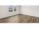 Spacious bedroom with wood-look floors and two large windows at 3641 Wayside Rd., Conway, SC 29527