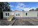 Attractive manufactured home with stone accents and a wooden staircase at 3641 Wayside Rd., Conway, SC 29527
