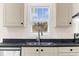Modern kitchen sink with dark countertop and stainless steel faucet at 3641 Wayside Rd., Conway, SC 29527