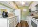 White kitchen with stainless steel appliances and view of the dining area at 609 Hillside Dr. S # C-10, North Myrtle Beach, SC 29582