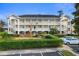 Three-story condo building with a charming facade and manicured hedges at 703 Riverwalk Dr. # 301, Myrtle Beach, SC 29579