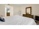 Bedroom with a queen bed, dresser, and mirror, offering a cozy atmosphere at 1101 Possum Trot Rd. # A103, North Myrtle Beach, SC 29582