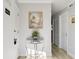 Bright entryway with a small table, plant, and artwork at 1101 Possum Trot Rd. # A103, North Myrtle Beach, SC 29582