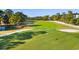Green golf course with pond and trees at 1101 Possum Trot Rd. # A103, North Myrtle Beach, SC 29582
