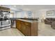 Kitchen boasts stainless steel appliances and wood cabinets at 1101 Possum Trot Rd. # A103, North Myrtle Beach, SC 29582