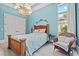 Light blue bedroom with wood bed frame and wicker chair at 1501 Serena Dr., Myrtle Beach, SC 29579