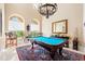 Game room with a pool table and ornate chandelier at 1501 Serena Dr., Myrtle Beach, SC 29579