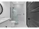 Bathroom with white vanity, walk-in shower, and dark gray door at 5009 Fiddlers Run, Myrtle Beach, SC 29579