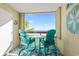 Ocean view balcony with teal chairs and table at 6100 N Ocean Blvd. # 207, North Myrtle Beach, SC 29582