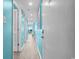 Light teal hallway with light wood floors at 6100 N Ocean Blvd. # 207, North Myrtle Beach, SC 29582