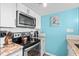 View of stove, microwave, and cookware in kitchen at 6100 N Ocean Blvd. # 207, North Myrtle Beach, SC 29582