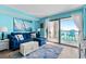 Living room with blue couch and ocean view at 6100 N Ocean Blvd. # 207, North Myrtle Beach, SC 29582