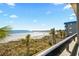 Oceanfront view from balcony showcasing beach and pier at 6100 N Ocean Blvd. # 207, North Myrtle Beach, SC 29582