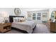 Spacious bedroom with a large window, plush bed, and a dresser at 724 Wallace Dr., Little River, SC 29566