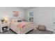 Charming bedroom with a white metal bed frame, pink bedding, and a window overlooking the backyard at 724 Wallace Dr., Little River, SC 29566