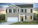 Two story house with neutral siding, dark green accents, and a two car garage at 724 Wallace Dr., Little River, SC 29566