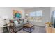 Bright and cozy home office with a sofa, ottoman, and large window at 724 Wallace Dr., Little River, SC 29566