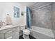 Clean bathroom, shower/tub combo, white vanity, and gray tile at 817 Wayne St., North Myrtle Beach, SC 29582