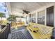 Relaxing front porch with yellow wooden bench and seating area at 817 Wayne St., North Myrtle Beach, SC 29582