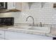 Double kitchen sink with a modern faucet and granite countertop at 817 Wayne St., North Myrtle Beach, SC 29582
