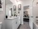 Clean bathroom with double vanity, a large mirror, and access to bedroom at 1212 Arizona Dr., Longs, SC 29568