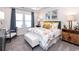 Luxurious main bedroom with king-size bed, stylish decor, and ensuite bathroom at 1212 Arizona Dr., Longs, SC 29568