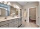 Double vanity bathroom with a large mirror, a linen closet, and a separate shower at 124 Barons Bluff Dr., Conway, SC 29526