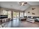 Spacious living room featuring hardwood floors, a large sectional sofa, and sliding glass doors leading to the backyard at 124 Barons Bluff Dr., Conway, SC 29526