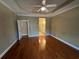 Main bedroom with hardwood floors, ceiling fan and en-suite bathroom at 1428 Saint Thomas Circle # B-1, Myrtle Beach, SC 29577