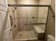 Walk-in shower with tiled walls and built-in seat at 1428 Saint Thomas Circle # B-1, Myrtle Beach, SC 29577