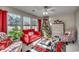 Bright living room featuring a Christmas tree, comfy seating, and large windows at 160 Somerworth Circle, Surfside Beach, SC 29575