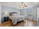 Spacious bedroom with wood floors, ceiling fan, and ample natural light at 166 Woodland Park Loop, Murrells Inlet, SC 29576