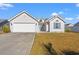 Charming one-story house with a two-car garage and landscaped lawn at 166 Woodland Park Loop, Murrells Inlet, SC 29576