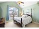 Bright bedroom with a floral-print bed and large window at 201 Deep Blue Dr., Myrtle Beach, SC 29579