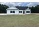 Newly constructed home with white siding, black windows, and a gray roof at 217 Shady Pines Ct., Conway, SC 29527