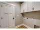 Laundry room with white cabinets and built-in shelving at 217 Shady Pines Ct., Conway, SC 29527