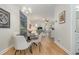 Bright dining area with a round table and four chairs, an open floor plan, and hardwood floors at 2740 Bayboro St., Loris, SC 29569