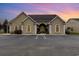 Attractive tan house with arched entry, featuring a sunset backdrop at 2740 Bayboro St., Loris, SC 29569