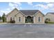 Tan house with a gray roof, arched entryway, and ample parking at 2740 Bayboro St., Loris, SC 29569