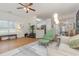 Living room with a comfy green chair and ottoman, open floor plan, and hardwood floors at 2740 Bayboro St., Loris, SC 29569