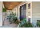 Inviting front porch with wooden floors and lush potted plants at 395 Buck Dr., Georgetown, SC 29440