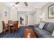 Living room with grey couch, coffee table, and view into dining area at 5200 N Ocean Blvd. # 1033, Myrtle Beach, SC 29577