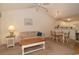 Living room with beige sofa, coffee table, and kitchen view at 562 Blue Stem Dr. # 54Q, Pawleys Island, SC 29585