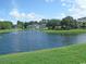 Serene pond with fountain, lush landscaping, and building view at 562 Blue Stem Dr. # 54Q, Pawleys Island, SC 29585