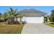 House exterior with a white garage door and landscaping at 6028 Andros Ln., Murrells Inlet, SC 29576