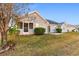 Gray house with a screened porch and landscaped yard at 818 Ingle Nook Ln., Longs, SC 29568